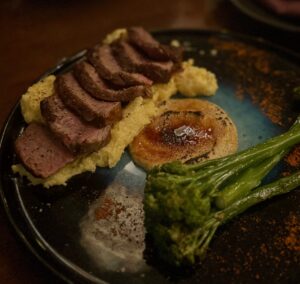 French-style 200gr Sabanah aged Eye Fillet a la Mustard flambeed with Brown Sugar and Mustard Sauce / Creamy polenta / Seasonal Vegetable